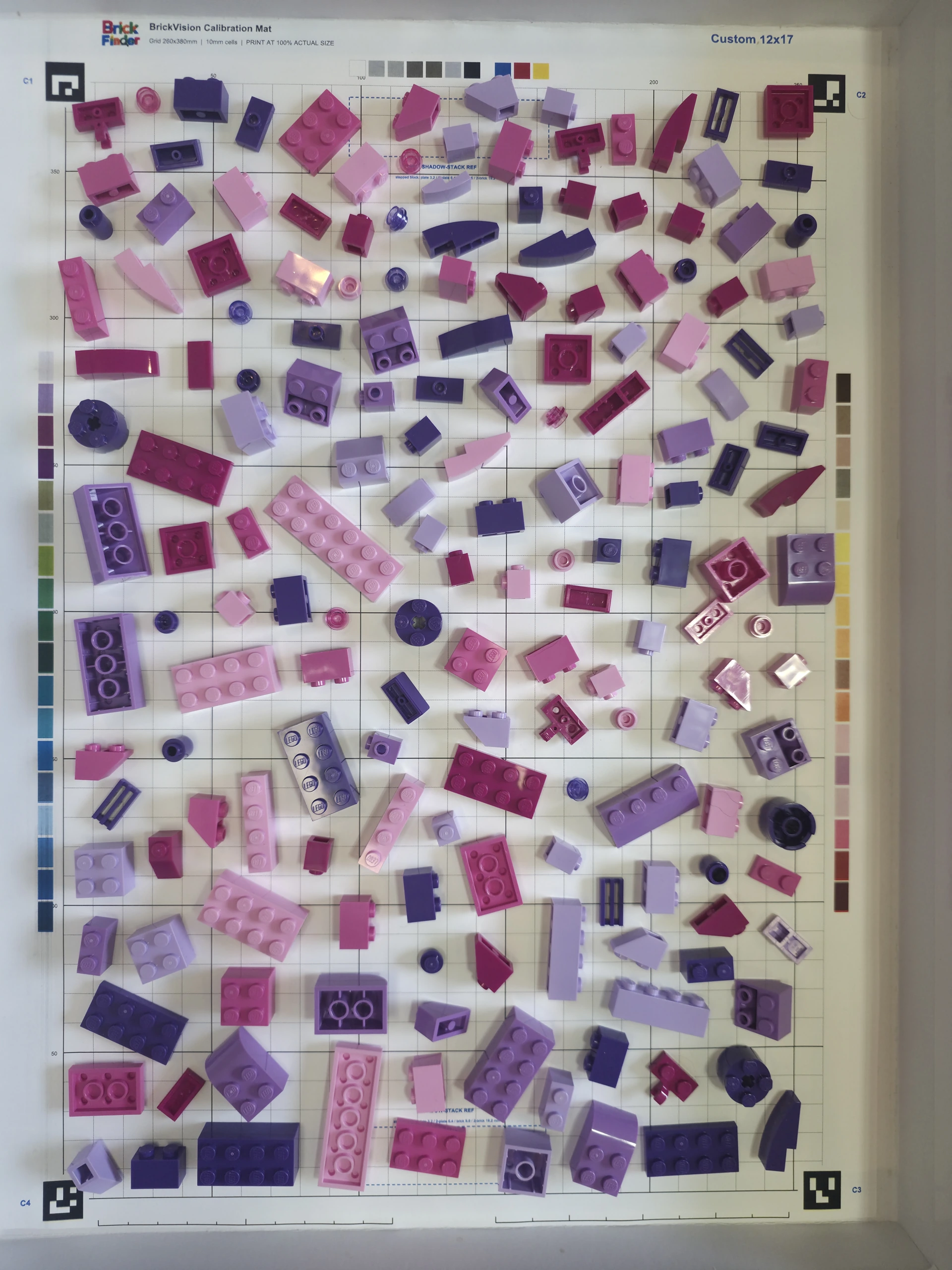 Original above photograph of the pink, purple, and magenta bricks on their calibration sheet